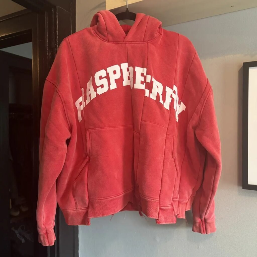 Detail view of Gallery Raspberry Hills Red Hoodie showing spliced stitching and premium cotton fabric texture.